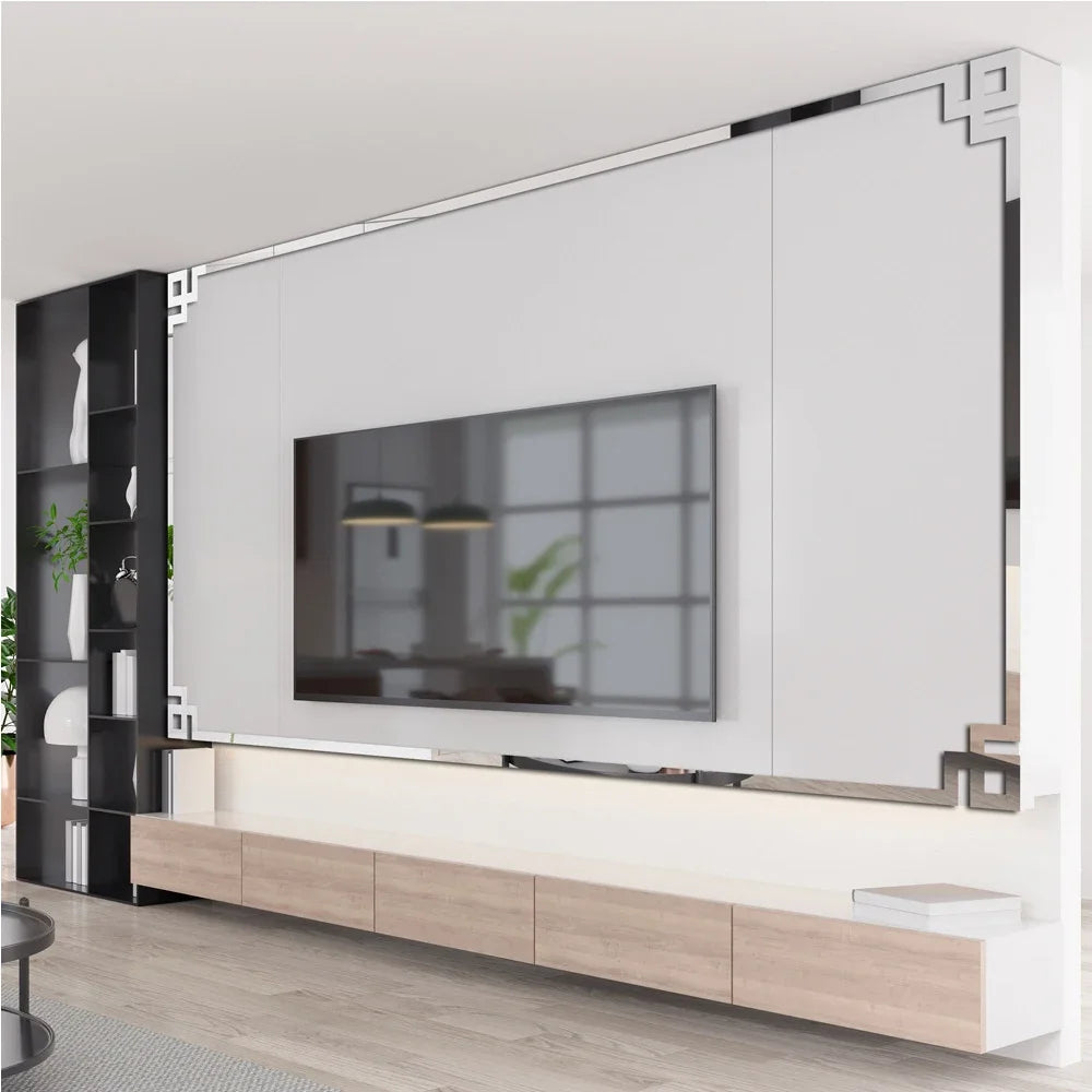 Modern home decor featuring a large acrylic mirror strip wall panel above a wooden floating shelf and a television.