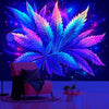 A vibrant neon blue cannabis leaf tapestry hangs against a dark, starry background above a pink armchair.