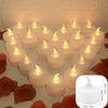 A display of white LED tealight candles with a warm white flicker set against a dark background.
