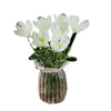A bouquet of white tulips in a clear glass vase.
