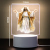 A glowing 3D LED night light depicting Jesus Christ with outstretched arms on a square panel.