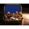 Miniature nativity scene set featuring Mary, Jesus, shepherd, and animal figurines inside a gold-colored box.
