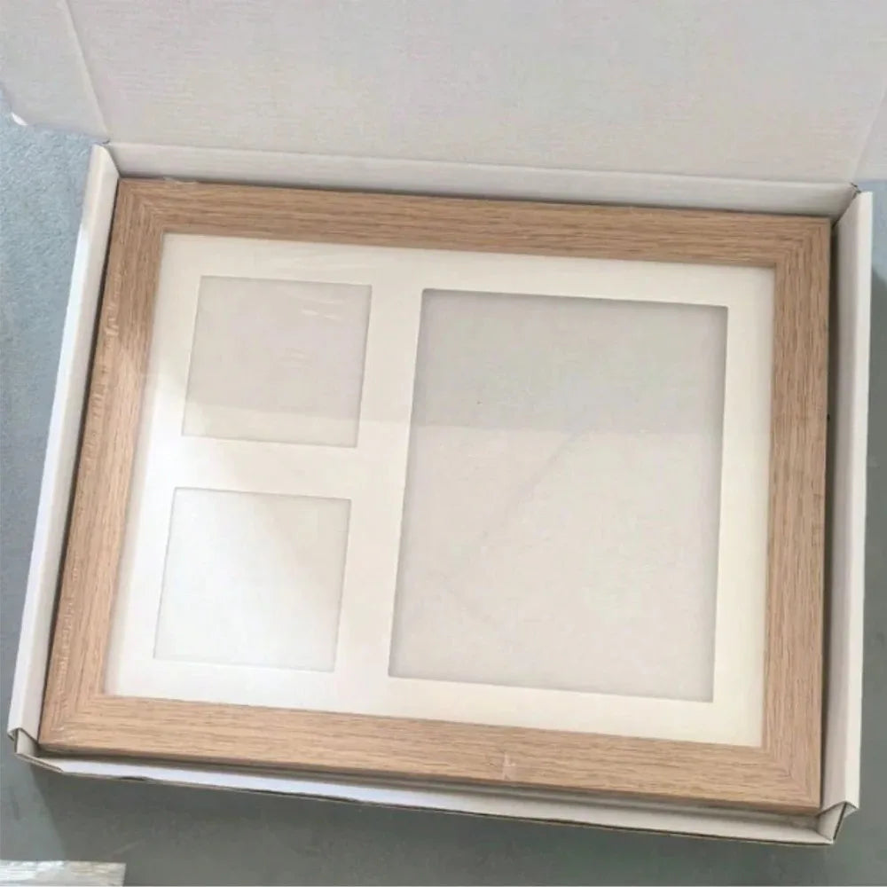 A photo frame containing two square spaces for photos, set in a wooden frame and packaged in a box.