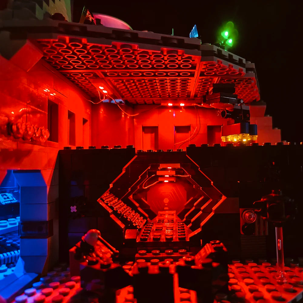 A detailed model of the Death Star with red lighting and an illuminated hexagonal interior display.