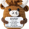 Handmade crochet brown and white horned animal doll with a positivity card
