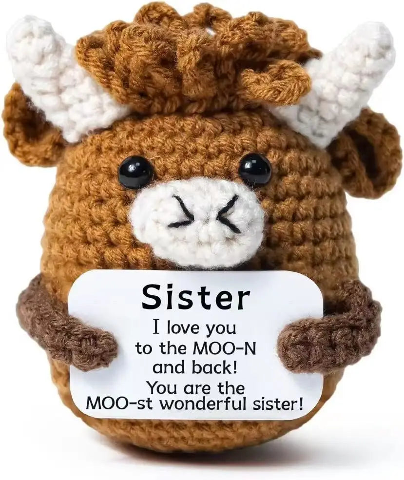 Handmade crochet brown and white horned animal doll with a positivity card