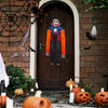 A dark wooden door decorated for Halloween with hanging ornaments including ghosts, bats, and pumpkins.