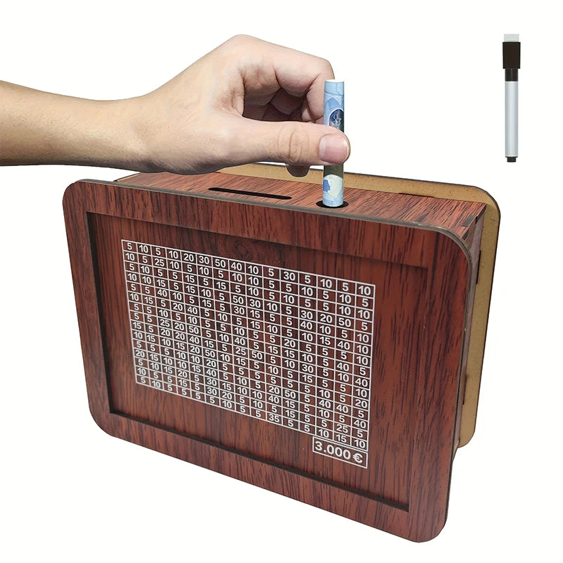 A wooden savings box with a progress tracker is being held by a hand, showing various savings amounts.
