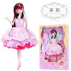 A pink ball-jointed doll with detailed makeup and a layered pink dress is displayed next to its packaging.