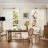 Natural linen sheer curtains with rod pocket hanging in a bright living room