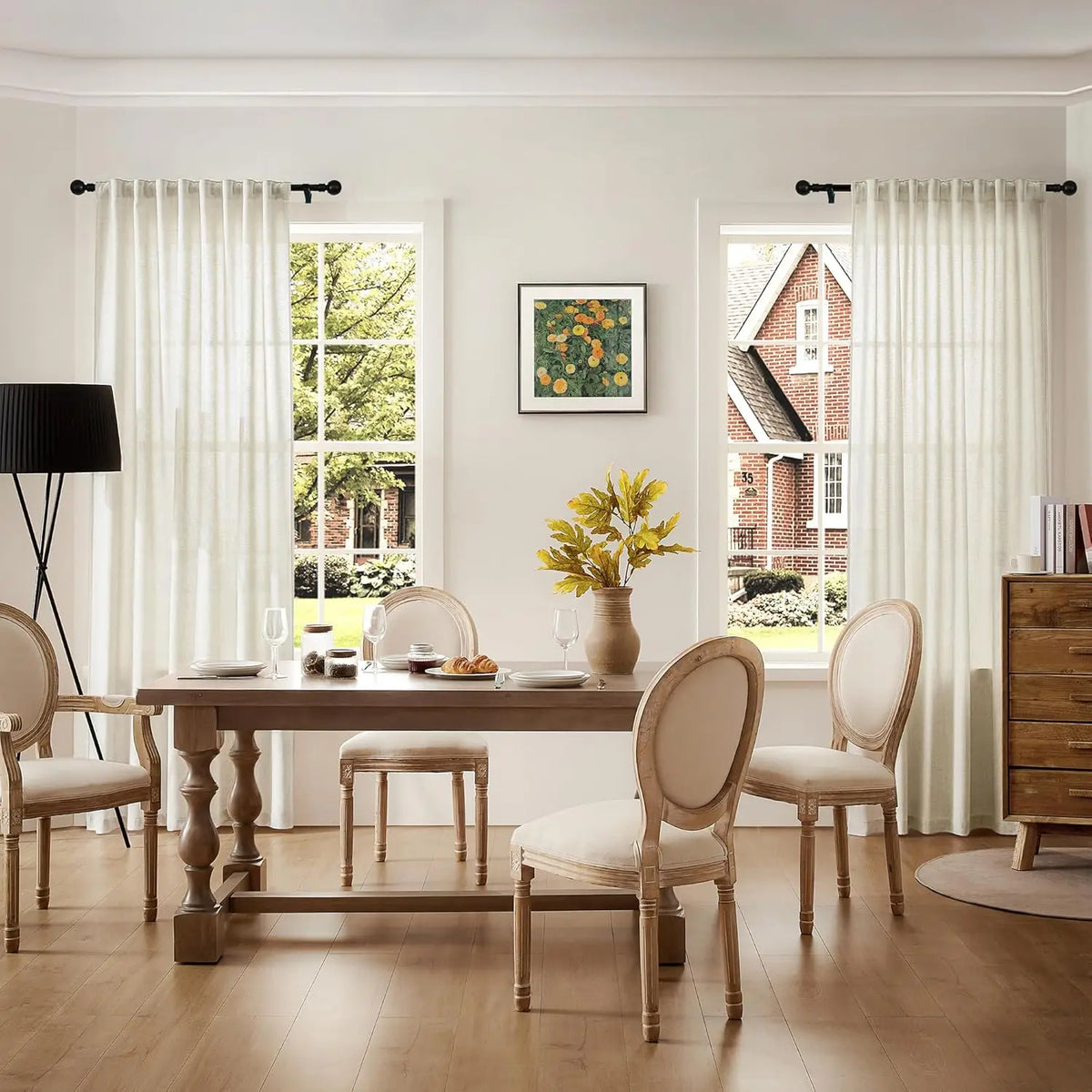 Natural linen sheer curtains with rod pocket hanging in a bright living room