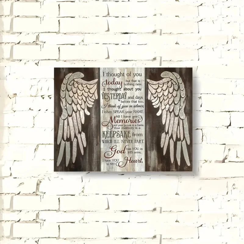 Wooden wall art featuring a silhouette of wings and text about memories and faith
