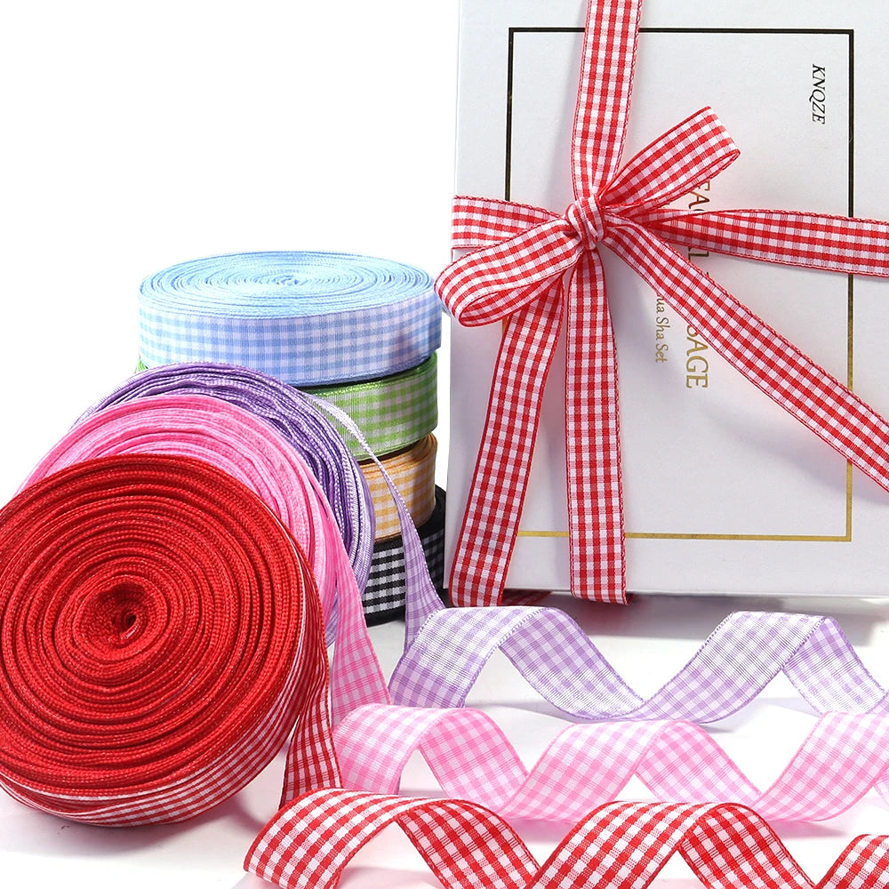 Rolls of red, pink, and purple gingham ribbon for gift wrapping and party decor