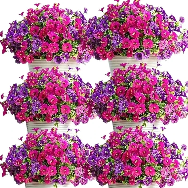 A vibrant floral arrangement of pink and purple silk morning glory vine flowers in a wreath form.