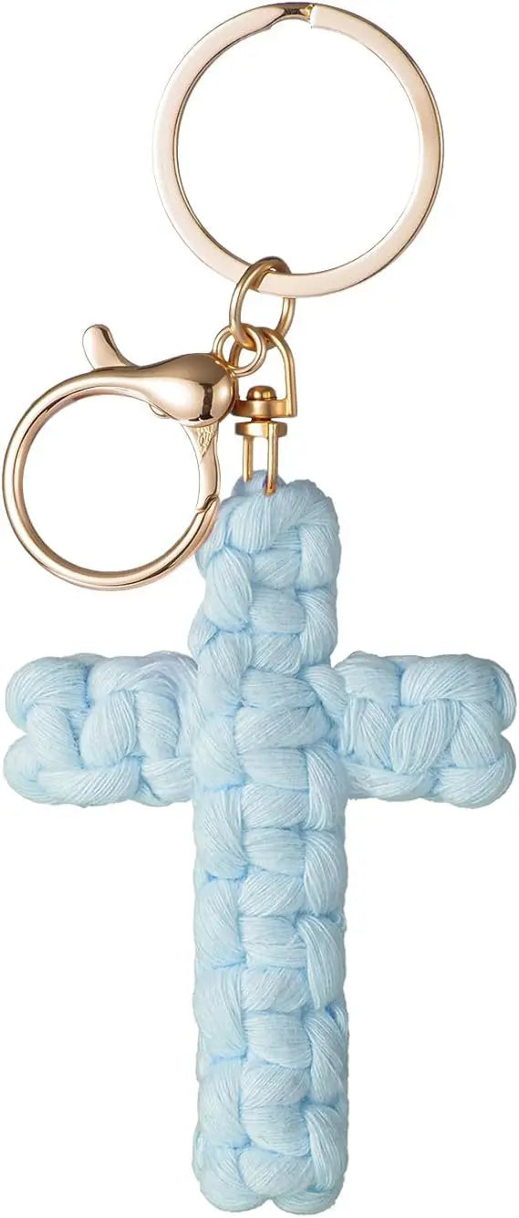 A light blue woven cross keychain with a gold-toned metal ring and clasp.