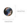 A circular decal showing a vibrant nebula and stars against a dark space background.
