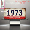 A distressed metal tin sign featuring the year 1973 in red and blue lettering, presented on a silver stand.
