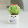 Handmade crochet sunflower desk companion with a smiling face, featuring green and red textures.