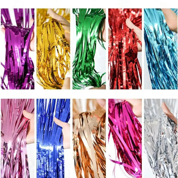 A collection of colorful rainbow foil fringe curtains in various shades including purple, gold, green, red, blue, and silver.