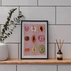 Framed canvas art featuring watercolor illustrations of various fruits like apples and citrus slices