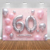 A pink balloon backdrop featuring silver and pink balloons with the number 60 and a birthday message