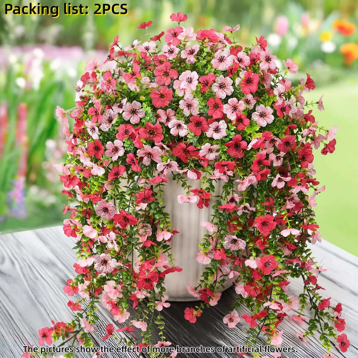 A dense arrangement of pink and red artificial flowers used for outdoor decor.