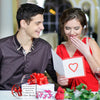 A man and a woman smiling while holding an acrylic keepsake gift box with a heart design.