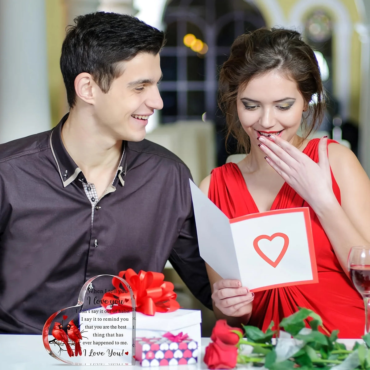 A man and a woman smiling while holding an acrylic keepsake gift box with a heart design.