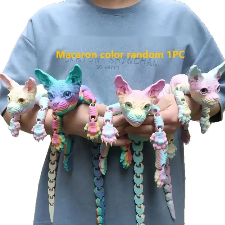 A hand holds a colorful random 1PC macaron color fidget toy featuring various textured cats.
