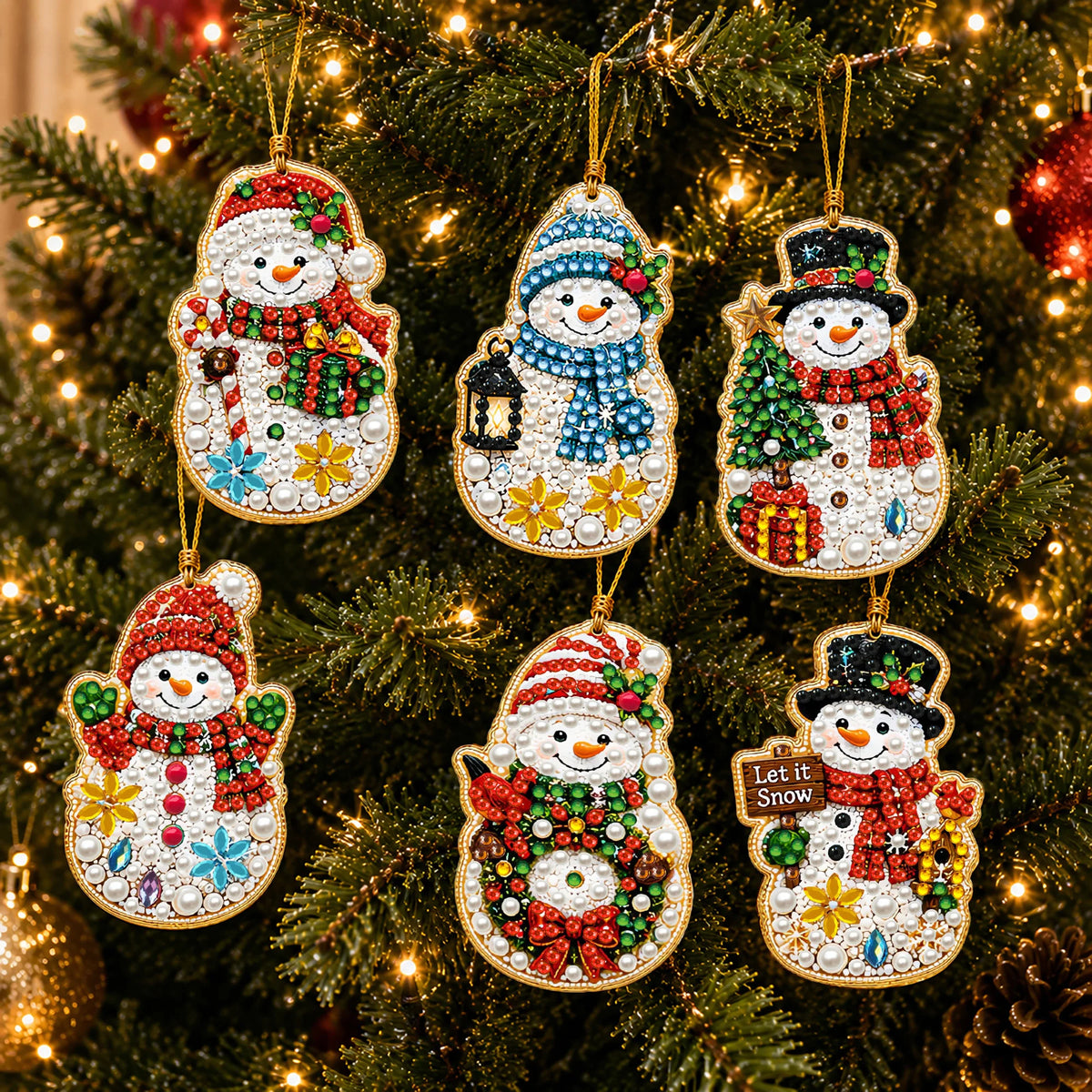 A set of Christmas diamond art ornaments featuring Santa, a snowman, and reindeer pendants hanging on a green Christmas tree.