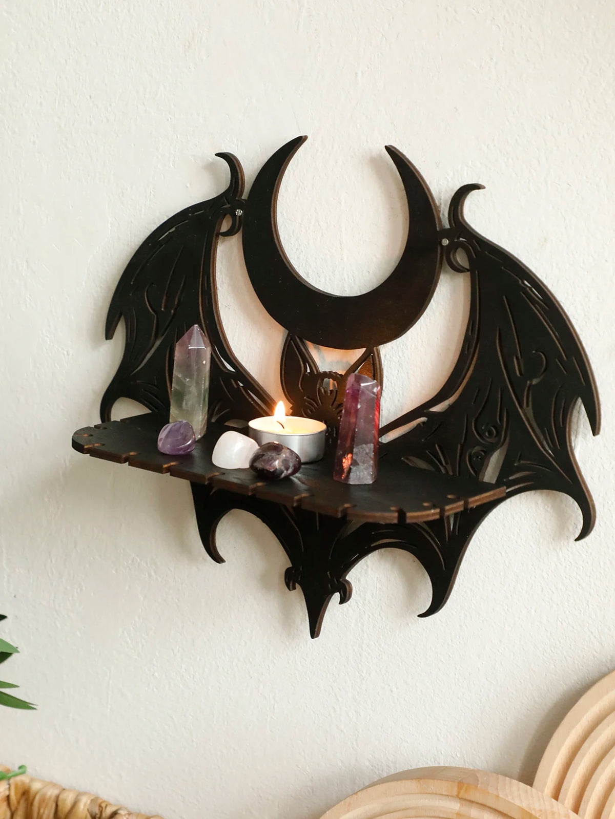Black gothic bat moon floating wall decor featuring crystals and a lit candle