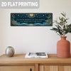 A rectangular dark blue metal tin sign featuring celestial designs and text, displayed on a wooden surface.
