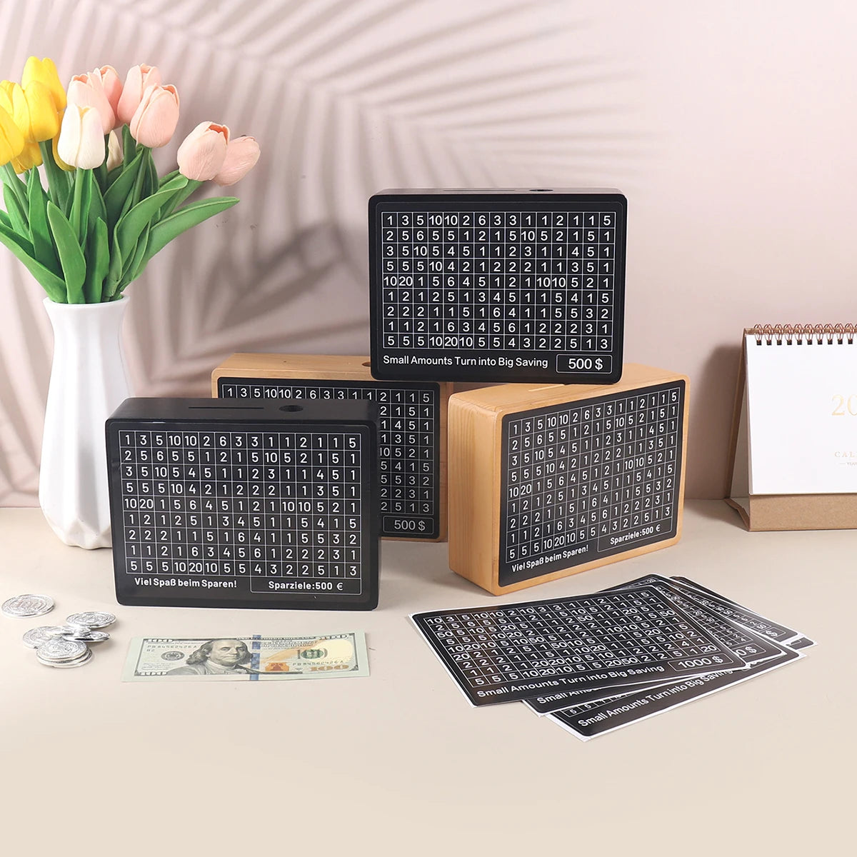 A set of wooden piggy bank savings boxes with numbered slots and coins displayed on a light surface.