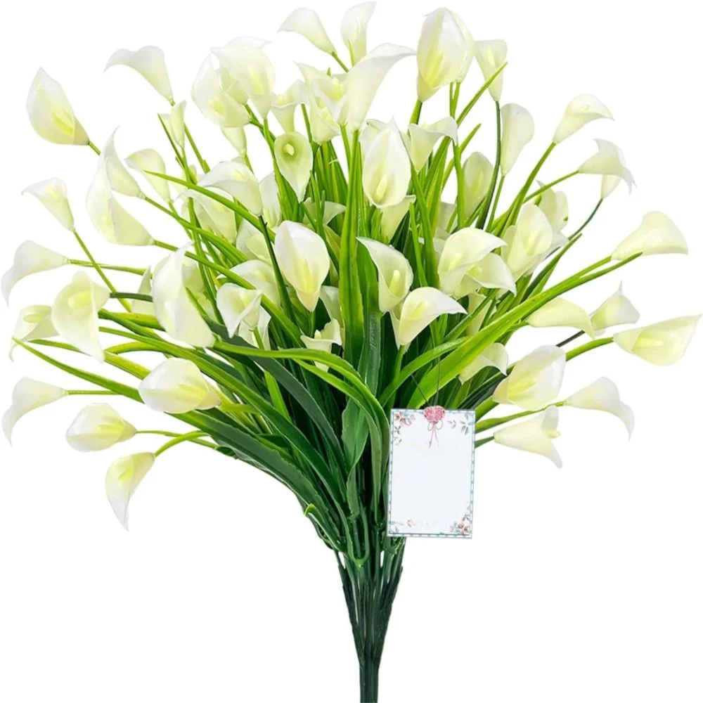 A bouquet of white artificial calla lilies with green stems and a small tag