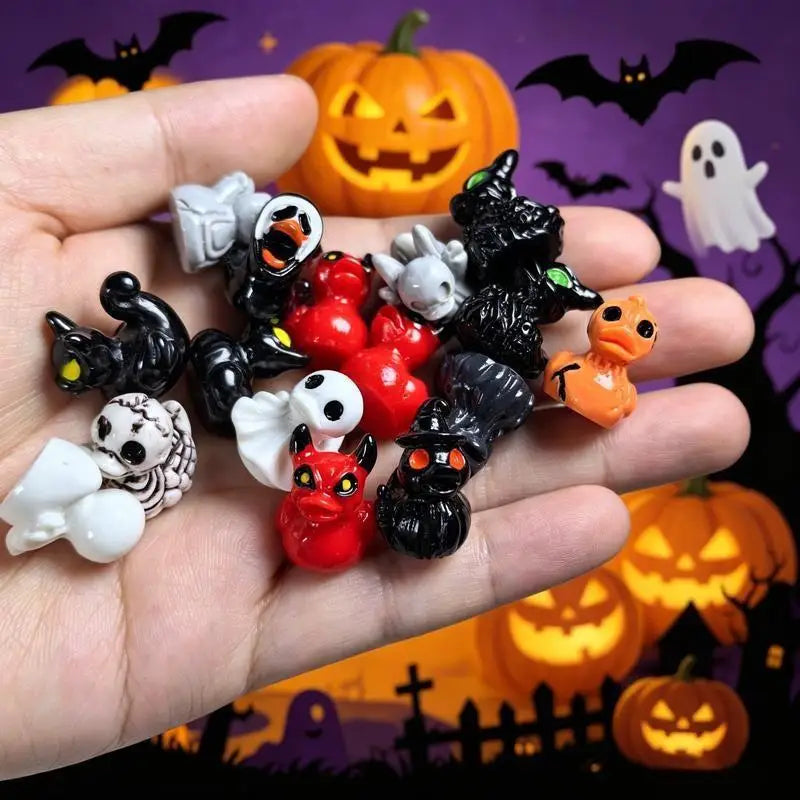 A hand holds a collection of quirky mini resin duck figurines with spooky designs in various colors like black, orange, and w