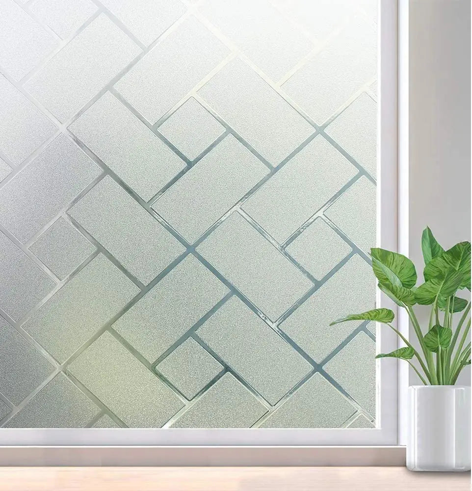 A close-up of frosted window privacy film with a geometric pattern displayed in a white frame.