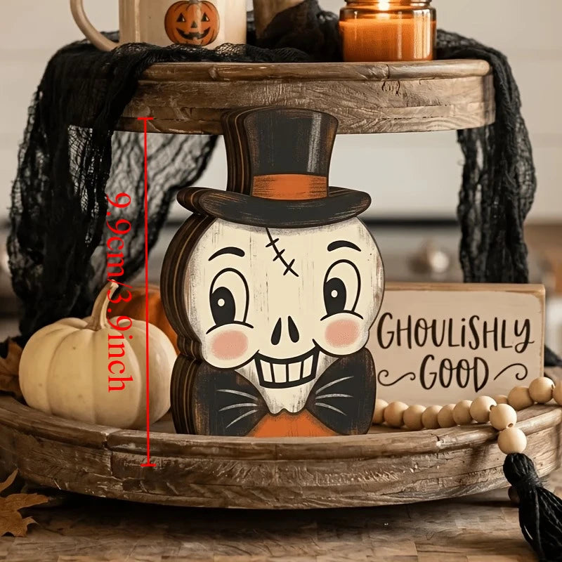 A wooden skull carving with a top hat and stitches is displayed on a rustic wooden tray.