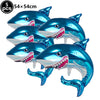 Five blue shark foil balloons used for ocean-themed party decoration