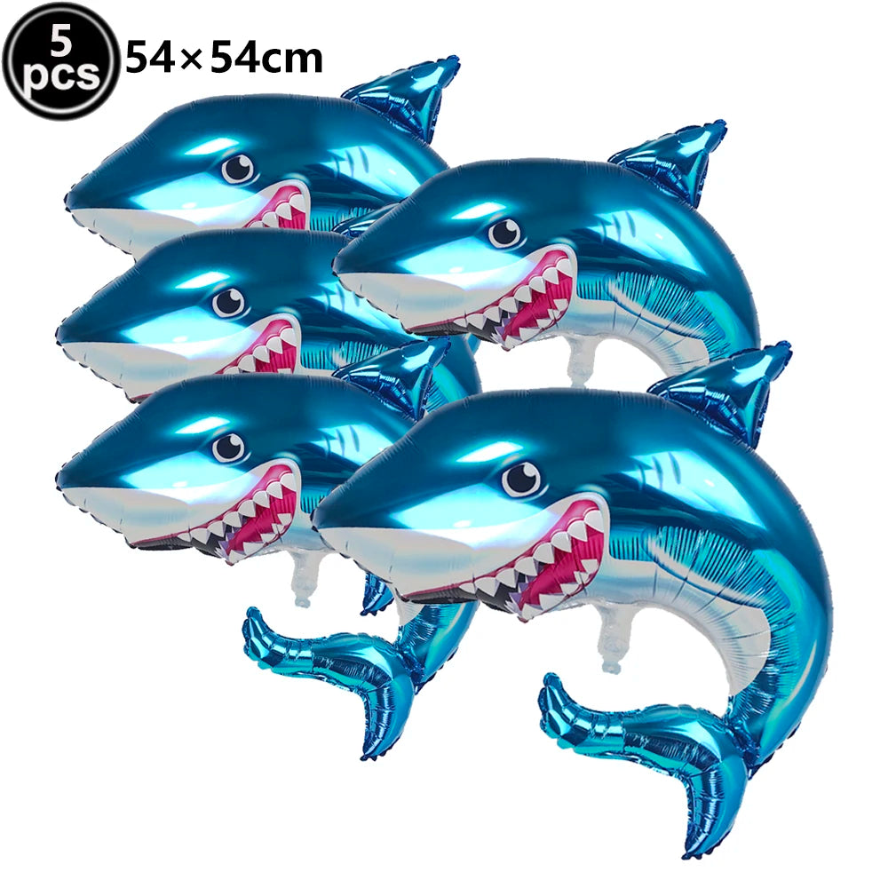 Five blue shark foil balloons used for ocean-themed party decoration