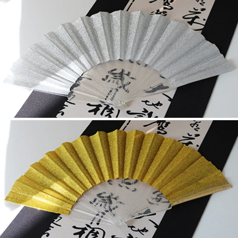 A golden glitter folding fan with transparent ribs shown in a fan shape.