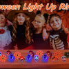 A display of Halloween light up rings featuring pumpkin, ghost, and spider designs.