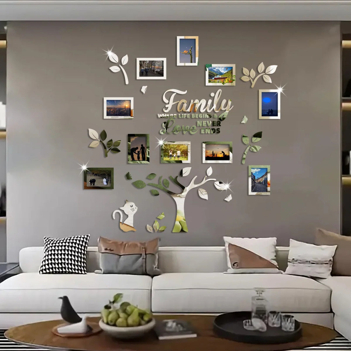 A wall collage featuring a family tree design with various framed photos and leaves on a gray wall.