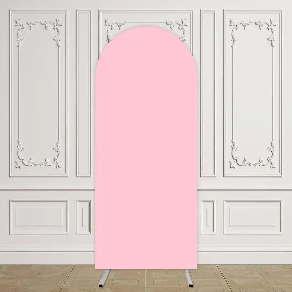 Arco de fondo elástico rosa exhibido contra una pared de paneles blancos.