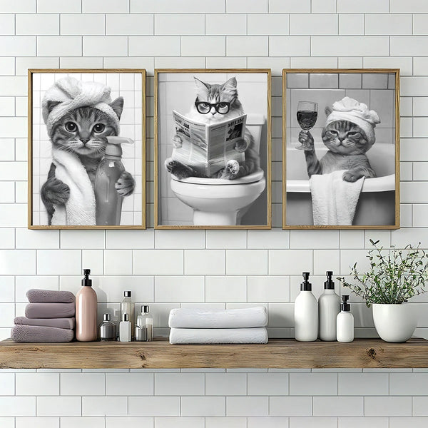 A set of three canvas art prints featuring cats in various poses for home decor