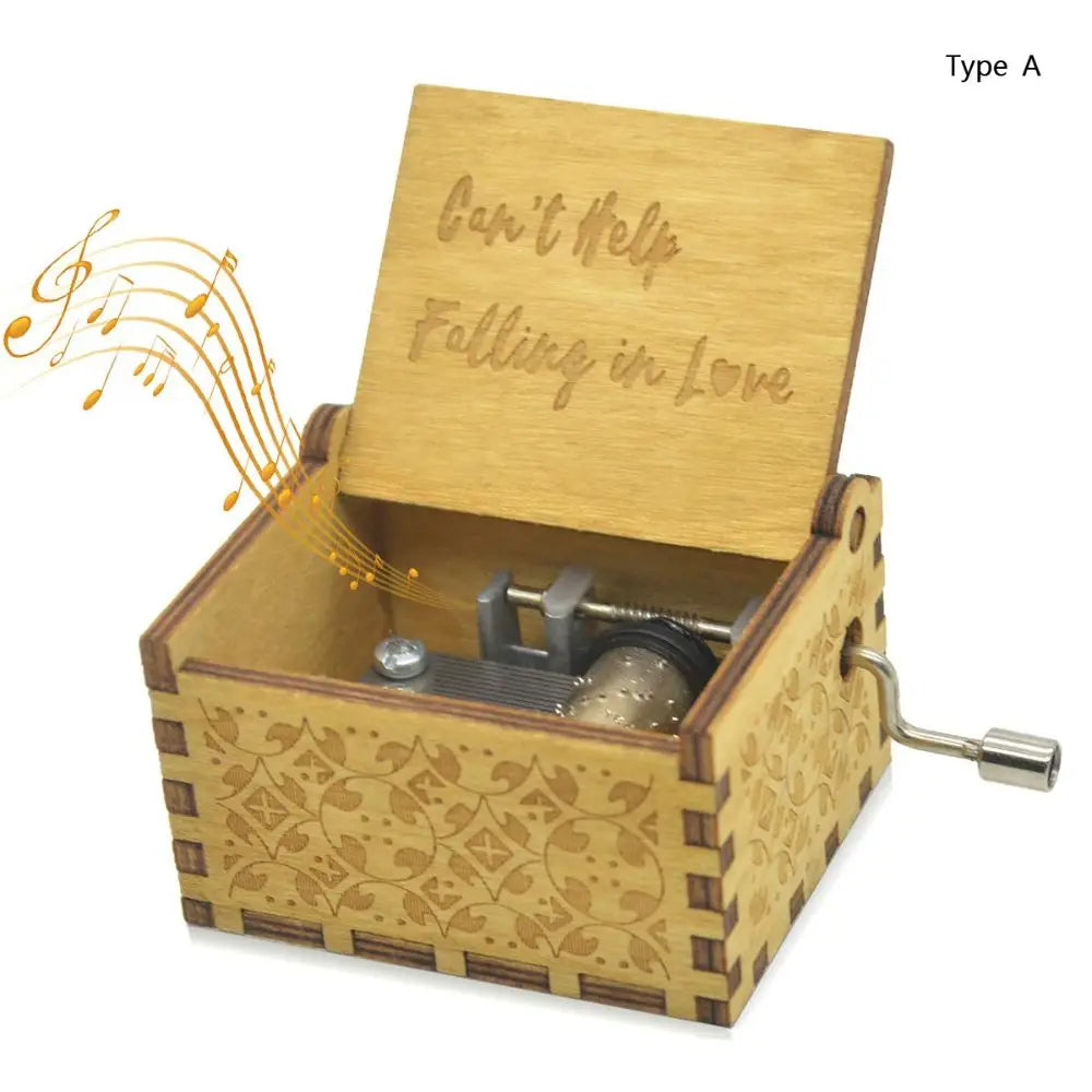 A vintage hand-cranked wooden music box with a lid engraved 'Can't Help Falling in Love' and a decorative wooden base.