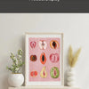 A framed canvas art display featuring watercolor paintings of various fruits like apples, pears, and citrus slices.