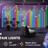 A display of colorful LED curtain lights illuminating a room, with a fluffy chair and a bundle of string lights visible.
