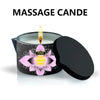 A black jar candle with a white peach floral design is shown lit on a surface.