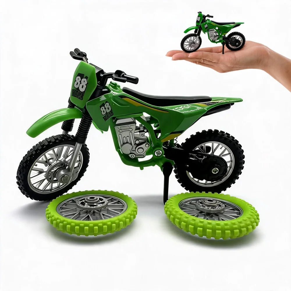 A green 1:12 scale off-road motorcycle model with spare wheels is held by a hand.