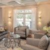 Modern bubble crystal LED wall sconces mounted on a light beige wall beside a large window.